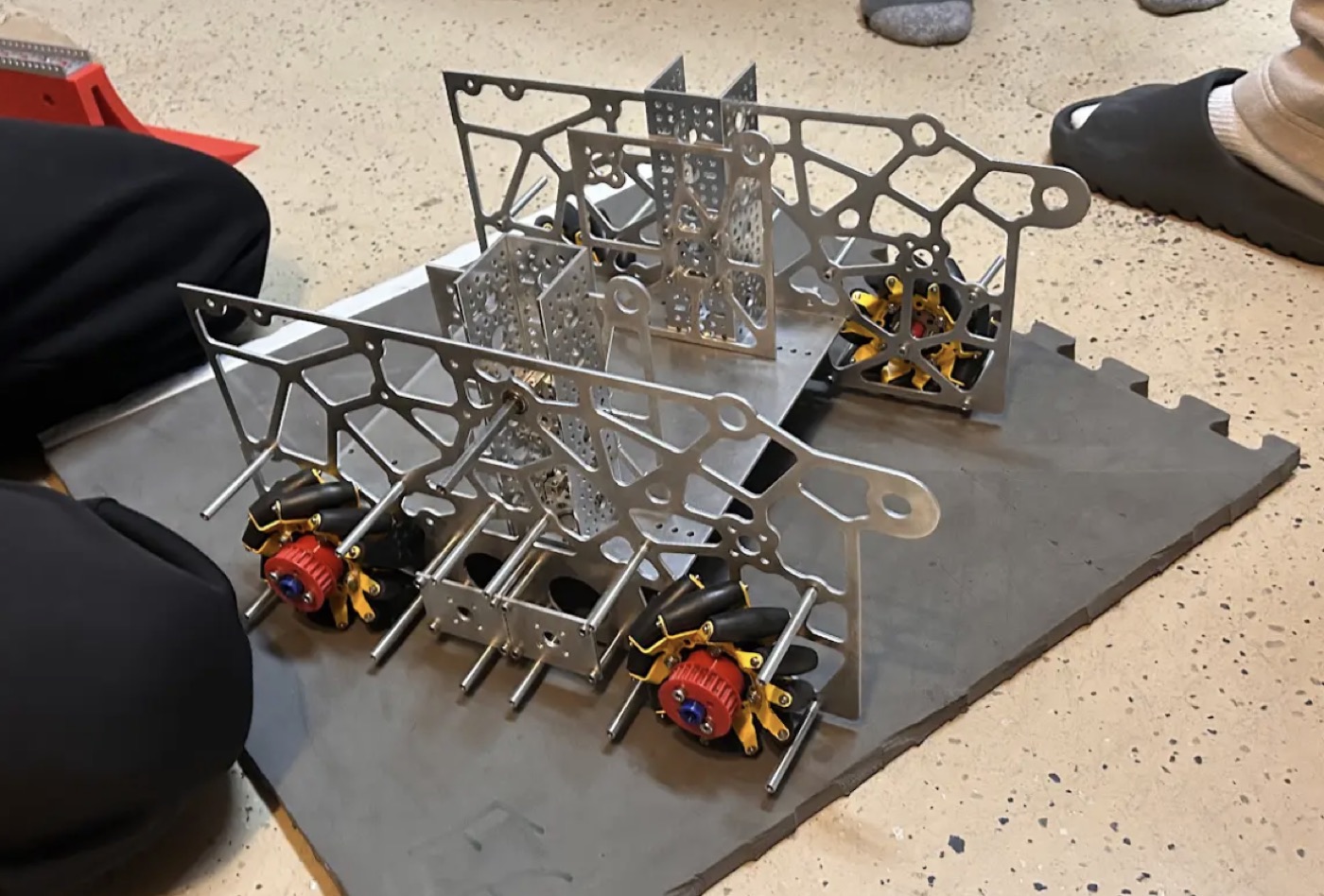 Physical FTC robot frame with side plates and mecanum wheels during assembly